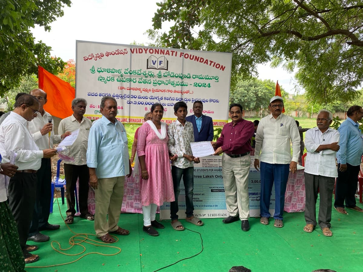 Student receiving certificate at 2024 outdoor ceremony