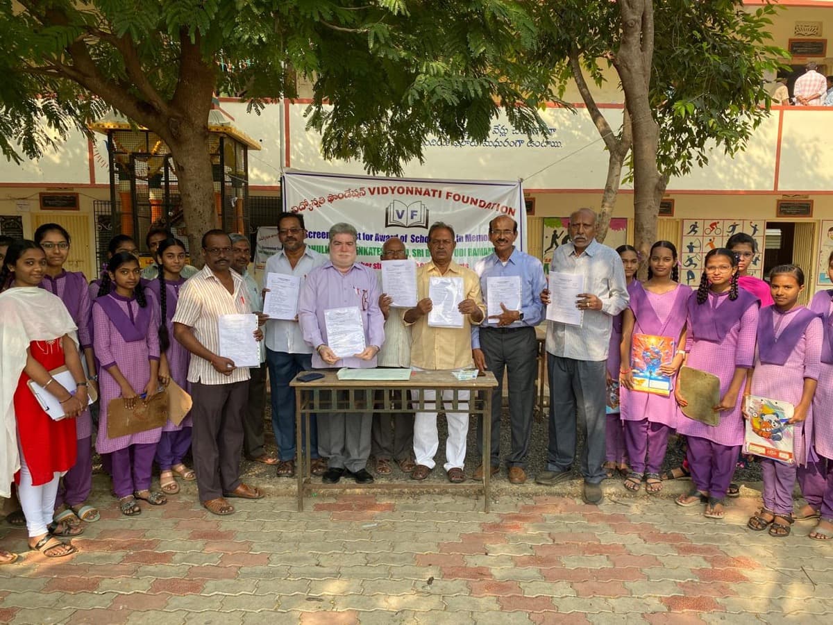 Students and teachers with certificates at school
